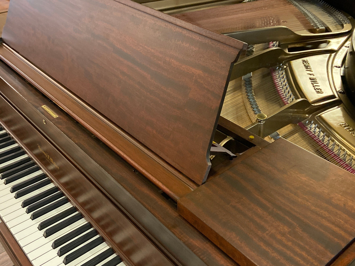 Beautifully restored and refinished grand Henry F Miller heirloom piano in Brigham Larson Pianos family heirloom restoration shop.