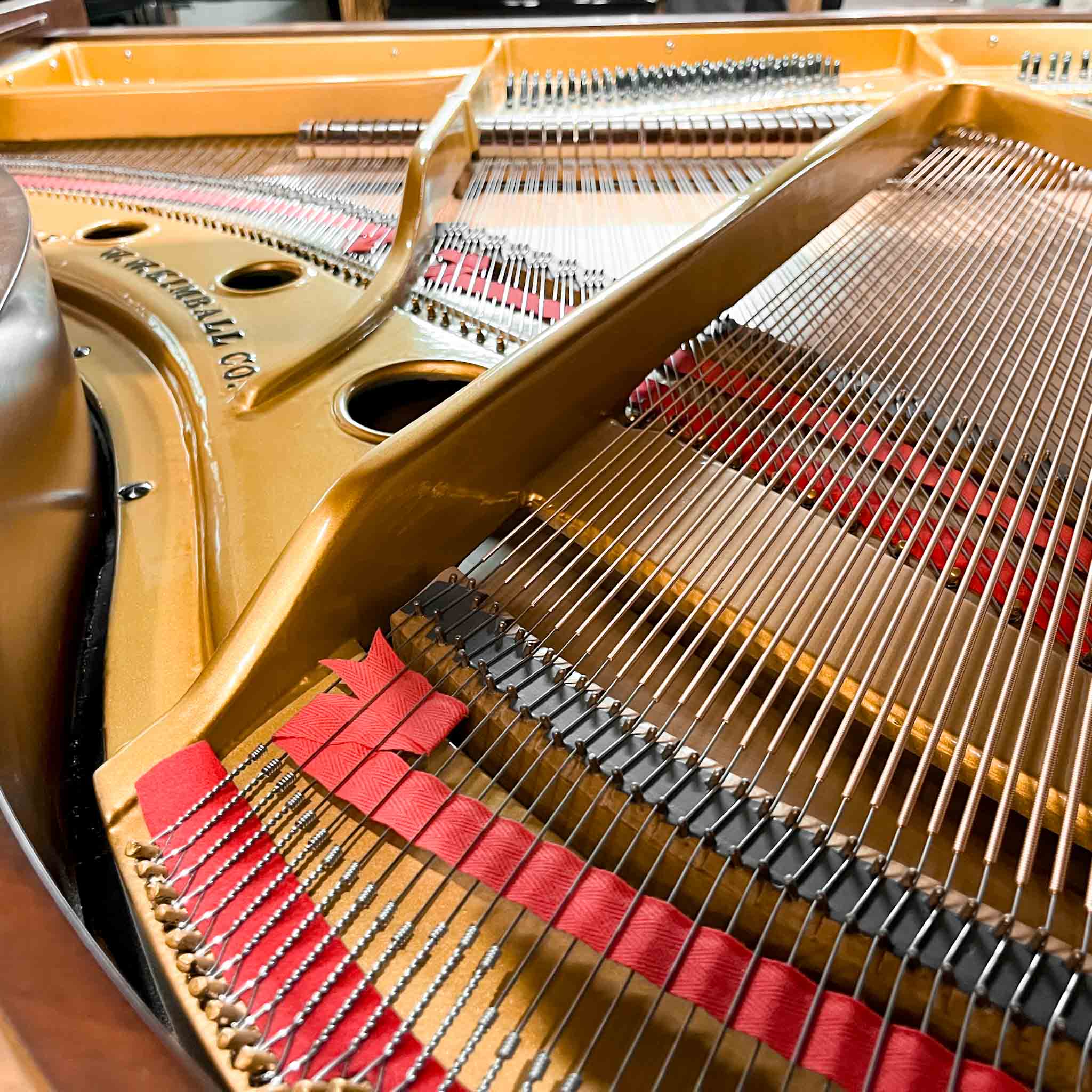Grand Piano Strings in Piano Restoration Shop at Brigham Larson Pianos and gold piano plate refinished.
