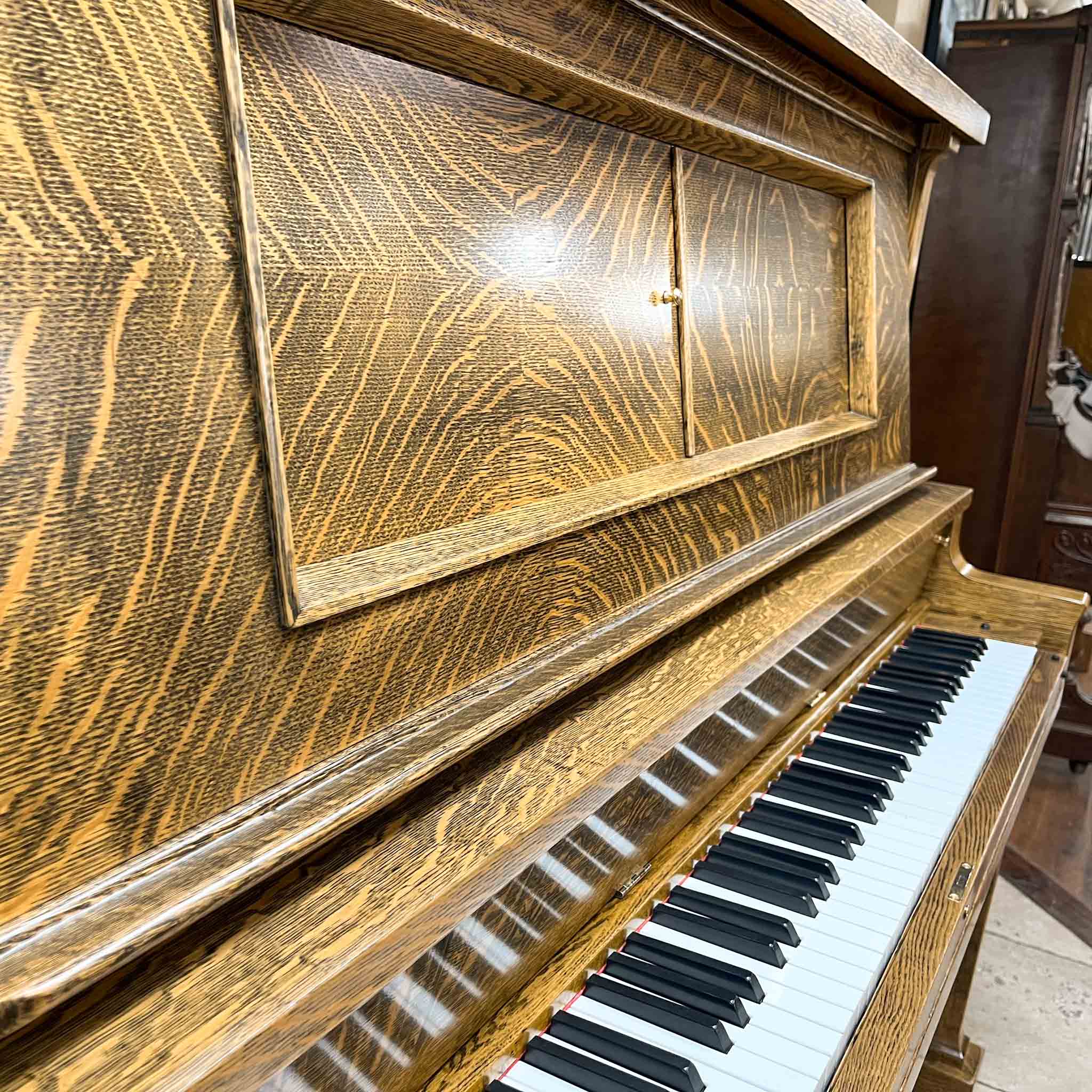 Beautiful upright heirloom hundred year old piano Shattuck vintage pnumatic player piano after restoration at Brigham Larson Pianos Family heirloom restoration shop in Orem, Utah.