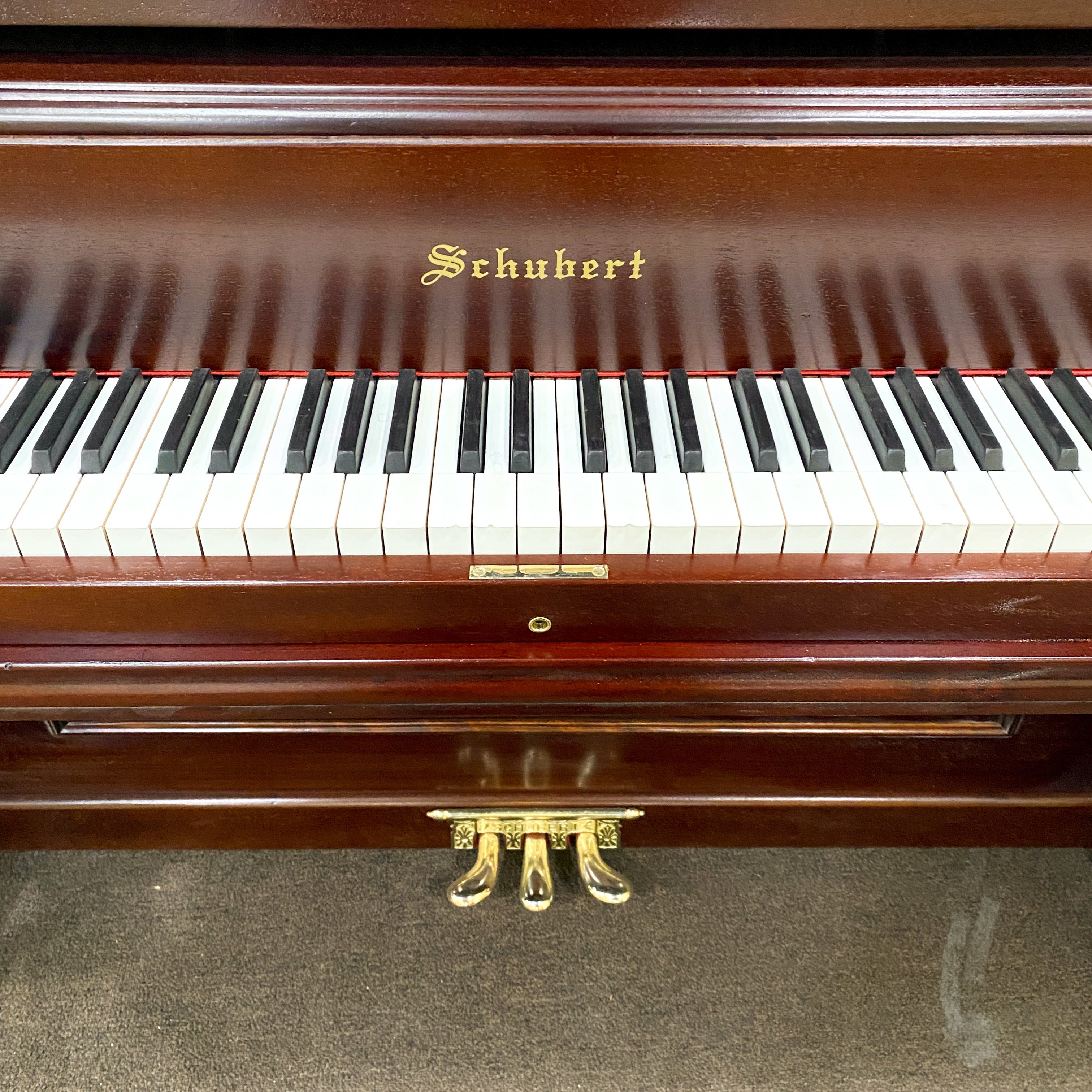 After restoration piano keys and decal,  piano hammers, piano action, piano plate, piano strings, piano tuning pins, photo of after the Schubert upright heirloom piano is restored and rebuilt and refinished to like new condition.