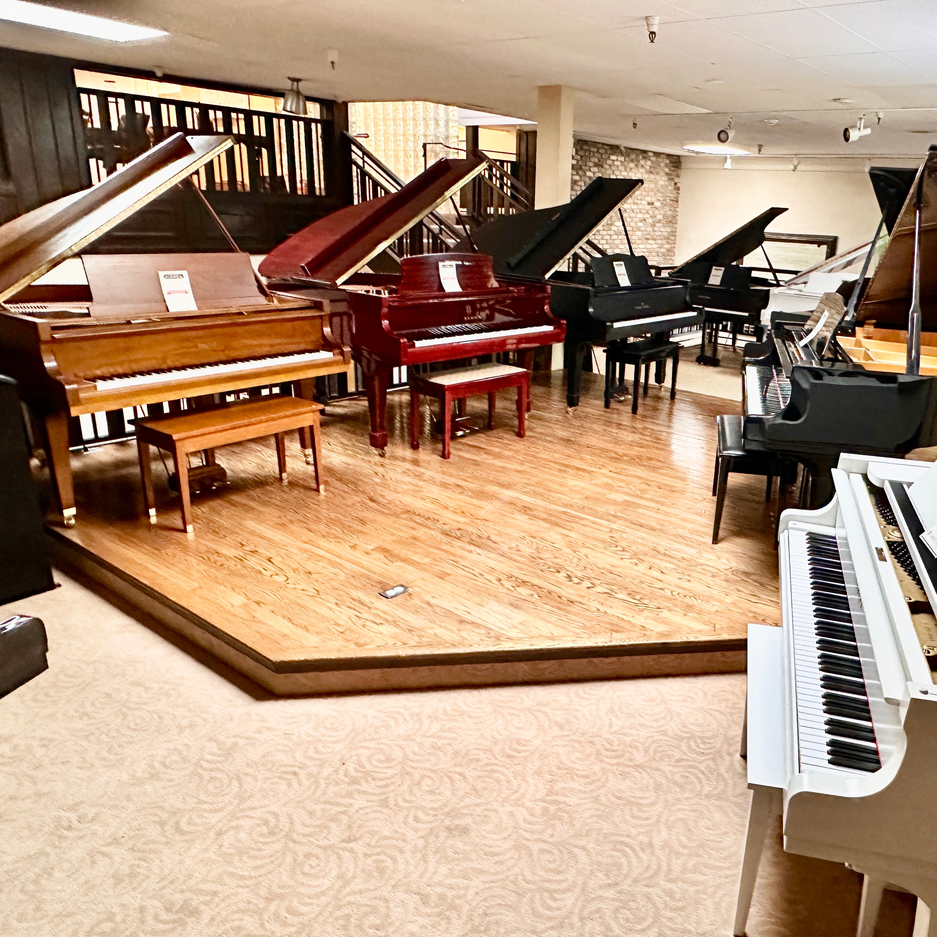 Brigham Larson Pianos balcony showroom of grand and upright pianos for sale new and refurbished or restored pianos, beautiful lined up in rows for sale pianos.