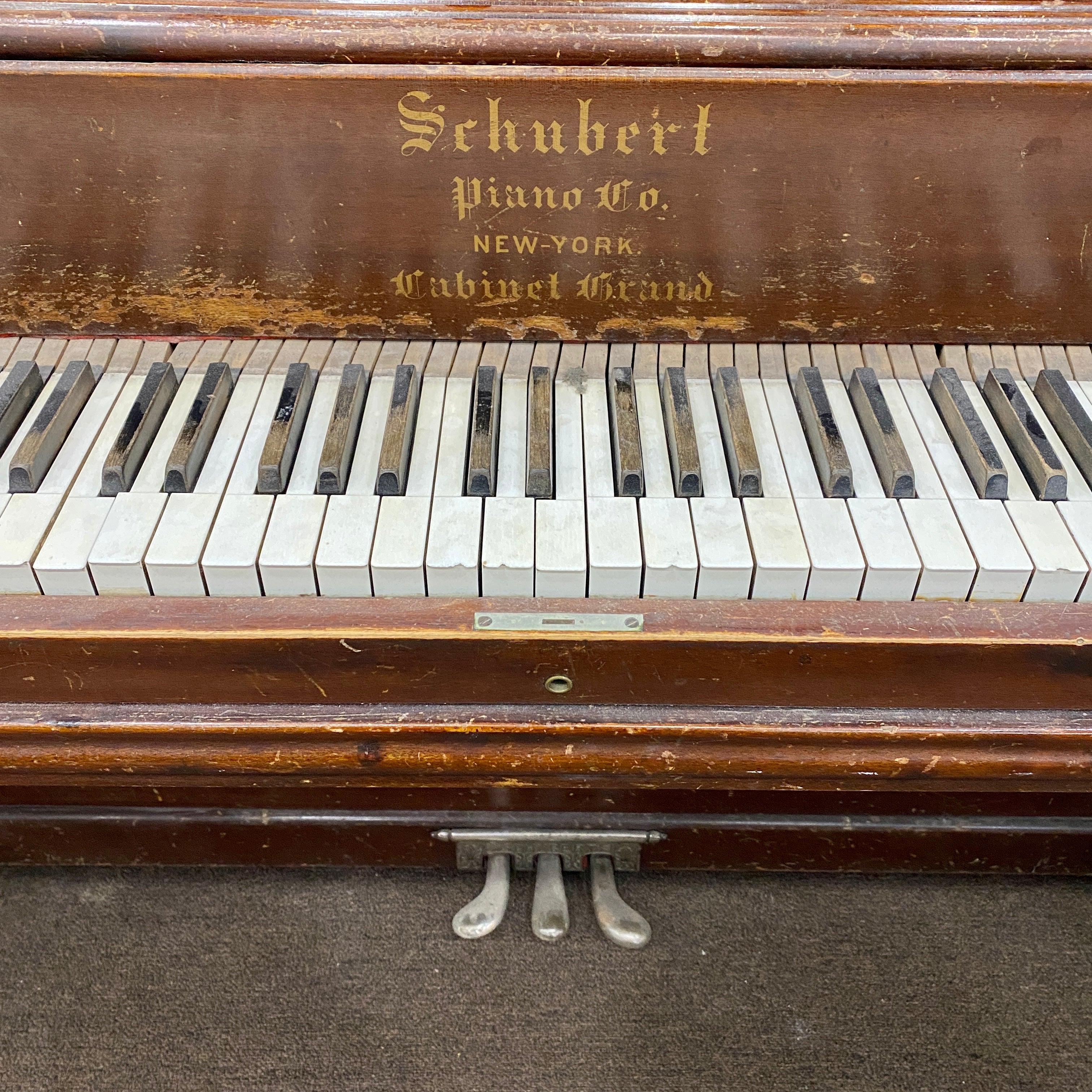 Before restoration piano keys and decal,  piano hammers, piano action, piano plate, piano strings, piano tuning pins, photo of before the Schubert upright heirloom piano is restored and rebuilt and refinished to like new condition.
