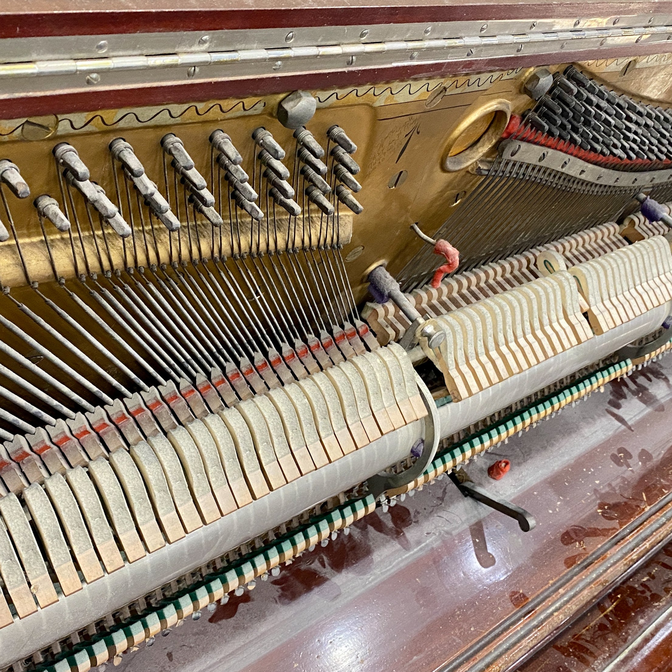 Before piano restoration piano hammers, piano action, piano plate, piano strings, piano tuning pins, photo of before the Schubert upright heirloom piano was restored and rebuilt and refinished to like new condition.
