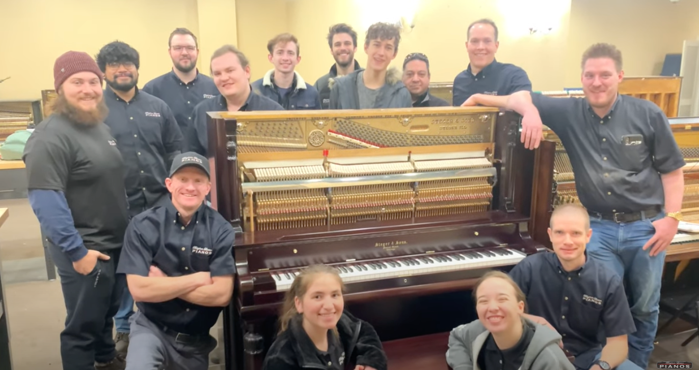 Load video: team of piano technicians at Brigham&#39;s piano shop