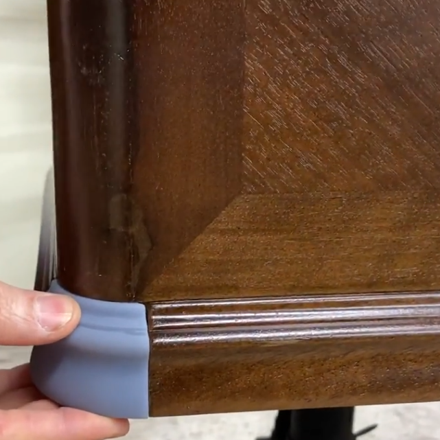 Hand holding a 3D printed piece to match a wooden piano trim that is missing  with visible grain at Brigham Larson Pianos in Orem, Utah piano heirloom piano restoration shop.