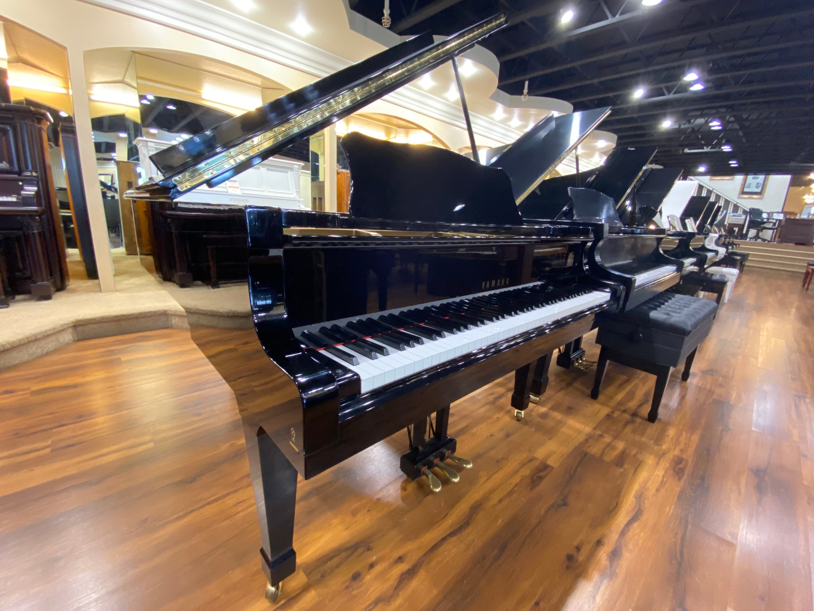 1981 Yamaha C5 polished black grand piano in showroom