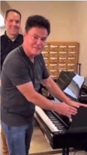 Load video: Donny Osmond visits Brigham Larson Pianos piano shop. Brigham shows Donny his  Yamaha C7 grand piano that is being converted into a digital piano for a show.    