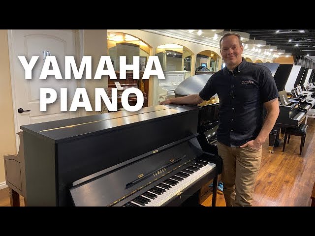 Load video: Brigham Larson showcasing the satin black finish Yamaha U1 upright piano in the piano sales showroom at Brigham Larson Pianos.