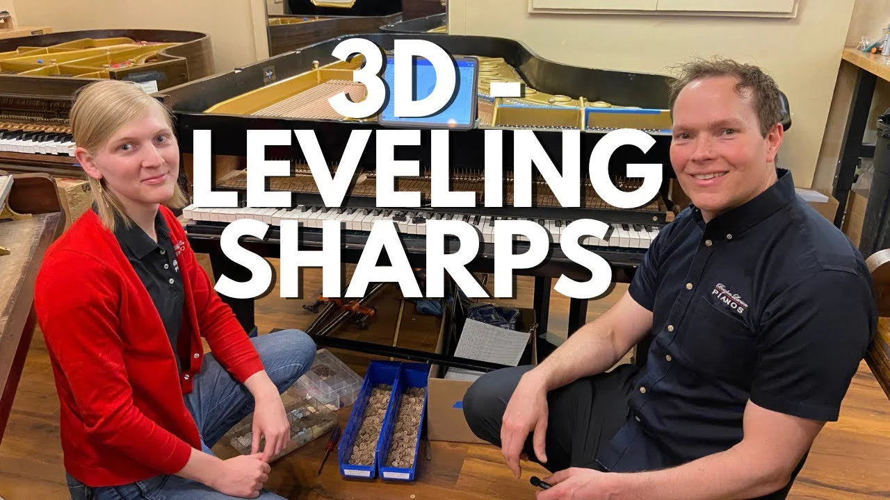 Two piano technicians sitting in front of a piano with text '3D Leveling Sharps' displayed at the Brigham Larson Pianos in Orem, Utah piano heirloom piano restoration shop.